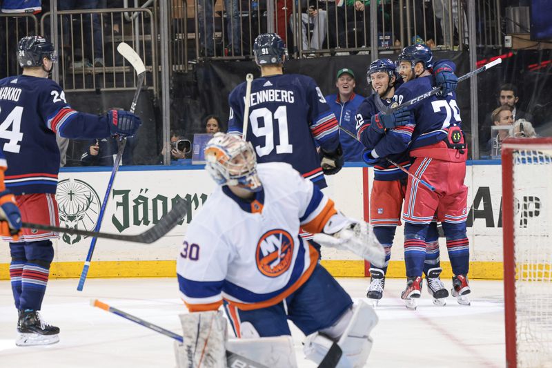 Mar 17, 2024; New York, New York, USA; New York Rangers center Jonny Brodzinski (22) celebrates his goal against New York Islanders goaltender Ilya Sorokin (30) with defenseman K'Andre Miller (79) and center Alex Wennberg (91) during the second period at Madison Square Garden. Mandatory Credit: Vincent Carchietta-USA TODAY Sports