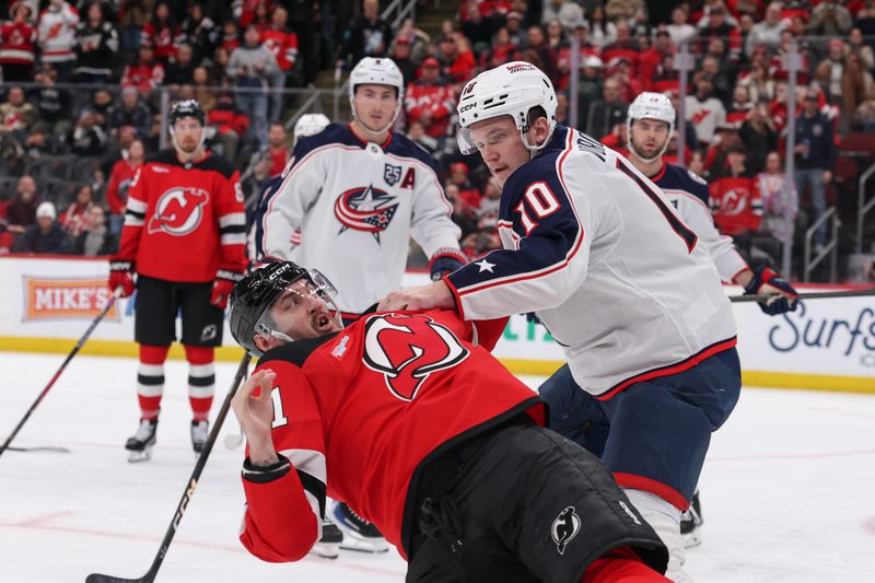 Dec 1, 2025; Newark, New Jersey, USA; Columbus Blue Jackets left wing Dmitri Voronkov (10) and New Jersey Devils right wing Stefan Noesen (11) fight during the second period at Prudential Center. Mandatory Credit: Ed Mulholland-Imagn Images