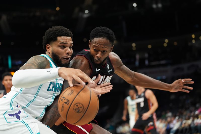 CHARLOTTE, NORTH CAROLINA - OCTOBER 08: Miles Bridges #0 of the Charlotte Hornets goes to the basket against Haywood Highsmith #24 of the Miami Heat during the first half of the preseason game at Spectrum Center on October 08, 2024 in Charlotte, North Carolina. NOTE TO USER: User expressly acknowledges and agrees that, by downloading and or using this photograph, User is consenting to the terms and conditions of the Getty Images License Agreement. (Photo by Grant Halverson/Getty Images)