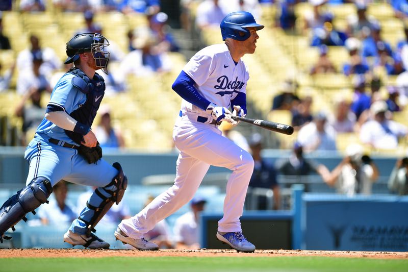 Jul 26, 2023; Los Angeles, California, USA; Los Angeles Dodgers first baseman Freddie Freeman (5) hits a single against the Toronto Blue Jays during the first inning at Dodger Stadium. Mandatory Credit: Gary A. Vasquez-USA TODAY Sports