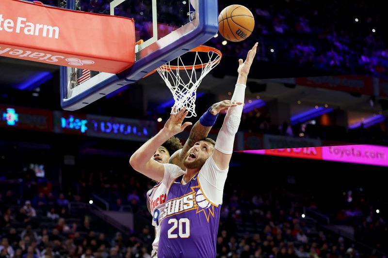 PHILADELPHIA, PENNSYLVANIA - JANUARY 06: Jusuf Nurkic #20 of the Phoenix Suns attempts to put up a shot against Kelly Oubre Jr. #9 of the Philadelphia 76ers during the first half at the Wells Fargo Center on January 06, 2025 in Philadelphia, Pennsylvania. NOTE TO USER: User expressly acknowledges and agrees that, by downloading and or using this photograph, User is consenting to the terms and conditions of the Getty Images License Agreement. (Photo by Emilee Chinn/Getty Images)