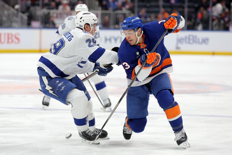 Dec 2, 2025; Elmont, New York, USA; New York Islanders center Mathew Barzal (13) fights for the puck against Tampa Bay Lightning right wing Pontus Holmberg (29) during the second period at UBS Arena. Mandatory Credit: Brad Penner-Imagn Images
