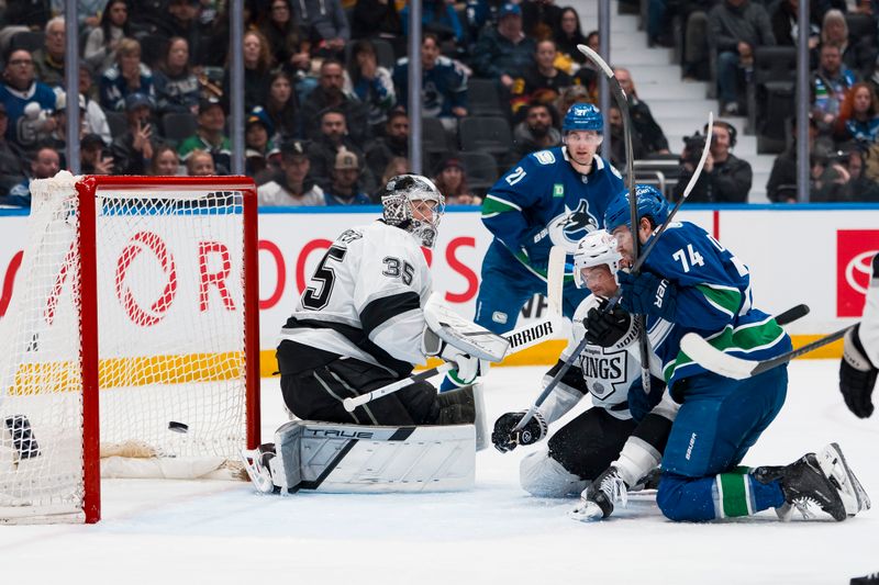 Apr 14, 2026; Vancouver, British Columbia, CAN; Vancouver Canucks defenseman Zeev Buium (24) scores on Los Angeles Kings goalie Darcy Kuemper (35) as forward Jake DeBrusk (74) battles with defenseman Brian Dumoulin (2) in the second period at Rogers Arena. Mandatory Credit: Bob Frid-Imagn Images