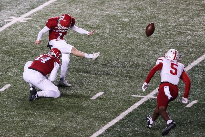 Dec 18, 2020; Piscataway, New Jersey, USA; Rutgers Scarlet Knights place kicker Valentino Ambrosio (1) kicks a field goal during the first half as Nebraska Cornhuskers cornerback Cam Taylor-Britt (5) defends at SHI Stadium. Mandatory Credit: Vincent Carchietta-USA TODAY Sports