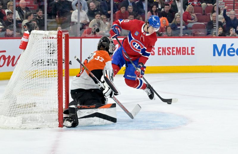 Apr 9, 2024; Montreal, Quebec, CAN; Montreal Canadiens forward Juraj Slafkovsky (20) scores a goal against Philadelphia Flyers goalie Samuel Ersson (33) during the second period at the Bell Centre. Mandatory Credit: Eric Bolte-USA TODAY Sports