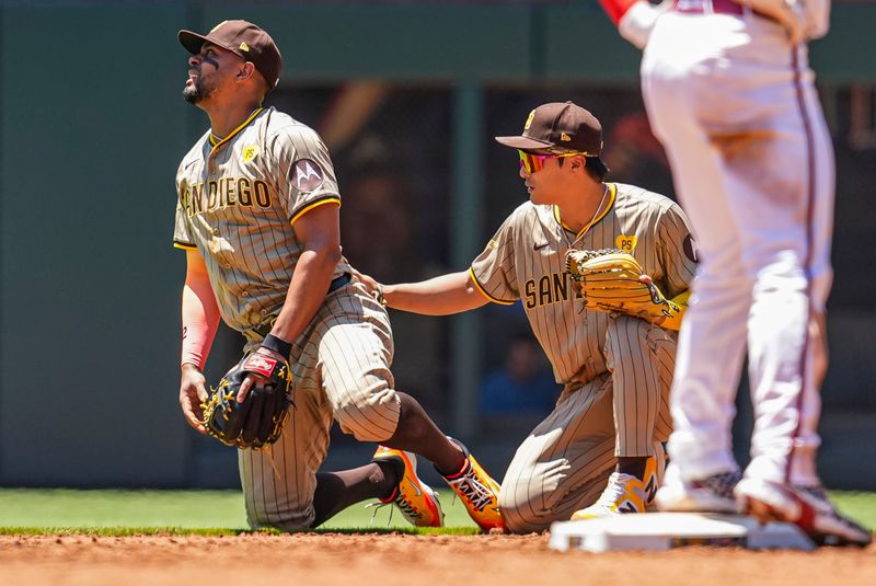 May 20, 2024; Cumberland, Georgia, USA; San Diego Padres second baseman Xander Bogaerts (2) is helped by shortstop Ha-Seong Kim (7) after being injured against the Atlanta Braves during the third inning at Truist Park. Mandatory Credit: Dale Zanine-USA TODAY Sports