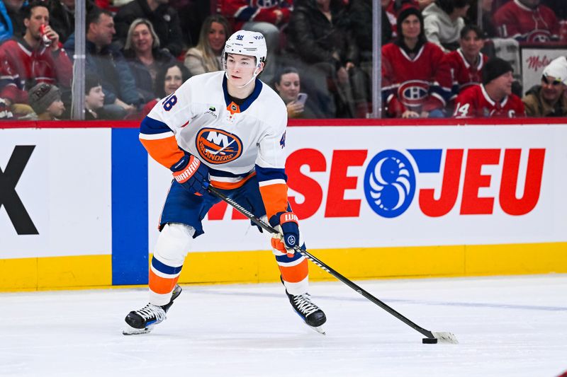Feb 26, 2026; Montreal, Quebec, CAN; New York Islanders defenseman Matthew Schaefer (48) plays the puck against the Montreal Canadiens during the third period at Bell Centre. Mandatory Credit: David Kirouac-Imagn Images