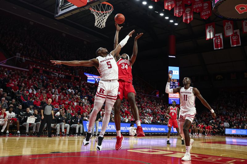 Mar 10, 2024; Piscataway, New Jersey, USA; Ohio State Buckeyes center Felix Okpara (34) rebounds against Rutgers Scarlet Knights forward Aundre Hyatt (5) during the second half at Jersey Mike's Arena. Mandatory Credit: Vincent Carchietta-USA TODAY Sports