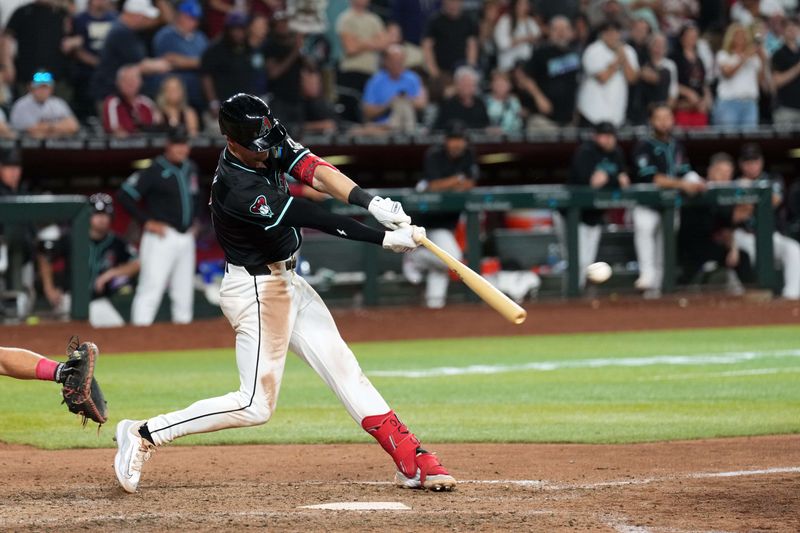 May 13, 2024; Phoenix, Arizona, USA; Arizona Diamondbacks shortstop Kevin Newman (18) hits a walk off two RBI single against the Cincinnati Reds during the ninth inning at Chase Field. Mandatory Credit: Joe Camporeale-USA TODAY Sports