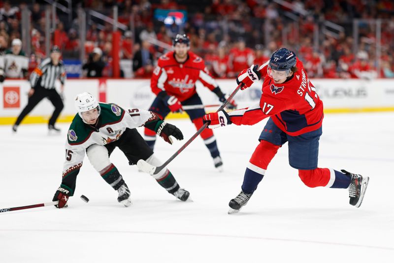 Mar 3, 2024; Washington, District of Columbia, USA; Washington Capitals center Dylan Strome (17) shoots the puck as Arizona Coyotes center Alex Kerfoot (15) defends in the third period at Capital One Arena. Mandatory Credit: Geoff Burke-USA TODAY Sports