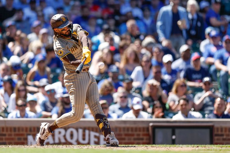 May 8, 2024; Chicago, Illinois, USA; San Diego Padres outfielder Fernando Tatis Jr. (23) hits an RBI-single against the Chicago Cubs during the fifth inning at Wrigley Field. Mandatory Credit: Kamil Krzaczynski-USA TODAY Sports