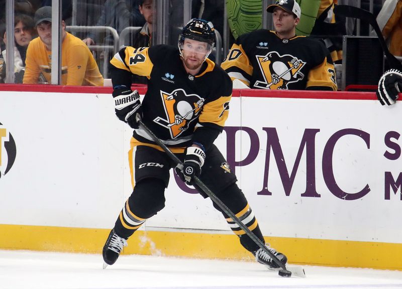 Oct 31, 2024; Pittsburgh, Pennsylvania, USA;  Pittsburgh Penguins defenseman Matt Grzelcyk (24) skates with the puck against the Anaheim Ducks during the first period at PPG Paints Arena. Mandatory Credit: Charles LeClaire-Imagn Images