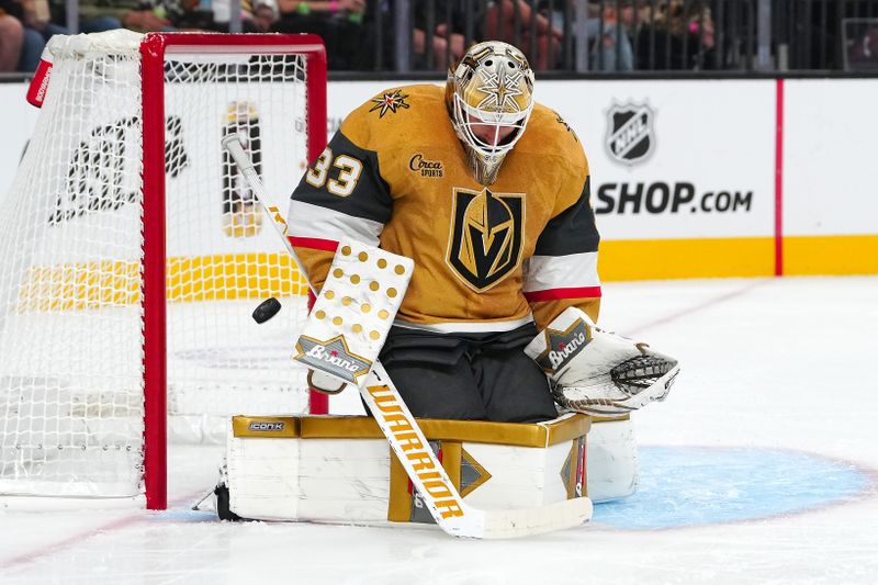 Sep 27, 2024; Las Vegas, Nevada, USA; Vegas Golden Knights goaltender Adin Hill (33) makes a save against the Utah Hockey Club during the first period at T-Mobile Arena. Mandatory Credit: Stephen R. Sylvanie-Imagn Images