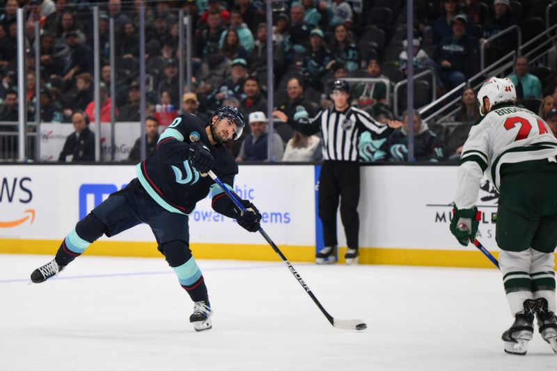 Dec 10, 2023; Seattle, Washington, USA; Seattle Kraken center Matty Beniers (10) shoots a goal shot against the Minnesota Wild during the second period at Climate Pledge Arena. Mandatory Credit: Steven Bisig-USA TODAY Sports