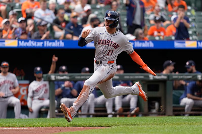 Aug 24, 2025; Baltimore, Maryland, USA; Houston Astros right fielder Cam Smith (11) scores a run on Houston Astros shortstop Jeremy Pena (3) (not pictured) RBI single against the Baltimore Orioles during the third inning at Oriole Park at Camden Yards. Mandatory Credit: Gregory Fisher-Imagn Images