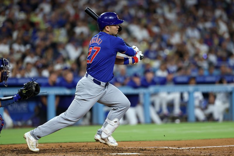 Sep 10, 2024; Los Angeles, California, USA;  Chicago Cubs designated hitter Seiya Suzuki (27) hits a RBI single during the eighth inning against the Los Angeles Dodgers at Dodger Stadium. Mandatory Credit: Kiyoshi Mio-Imagn Images