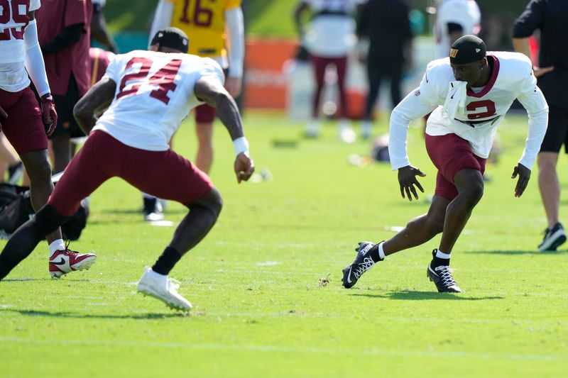 Washington Commanders cornerback Michael Davis (24) and cornerback Mike Sainristil (2) do drills during a joint practice with the Miami Dolphins at the NFL football team's training facility, Thursday, Aug. 15, 2024, in Miami Gardens, Fla. (AP Photo/Lynne Sladky)