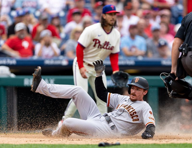 Aug 23, 2023; Philadelphia, Pennsylvania, USA; San Francisco Giants right fielder Wade Meckler (53) slides into home plate for a run in front of Philadelphia Phillies starting pitcher Michael Lorenzen (22) during the third inning at Citizens Bank Park. Mandatory Credit: Bill Streicher-USA TODAY Sports