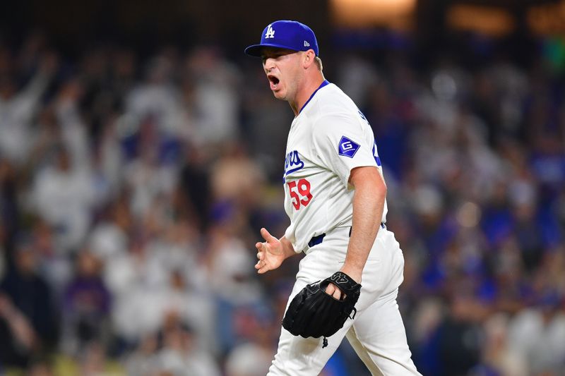 Aug 29, 2024; Los Angeles, California, USA; Los Angeles Dodgers pitcher Evan Phillips (59) celebrates the victory against the Baltimore Orioles at Dodger Stadium. Mandatory Credit: Gary A. Vasquez-USA TODAY Sports