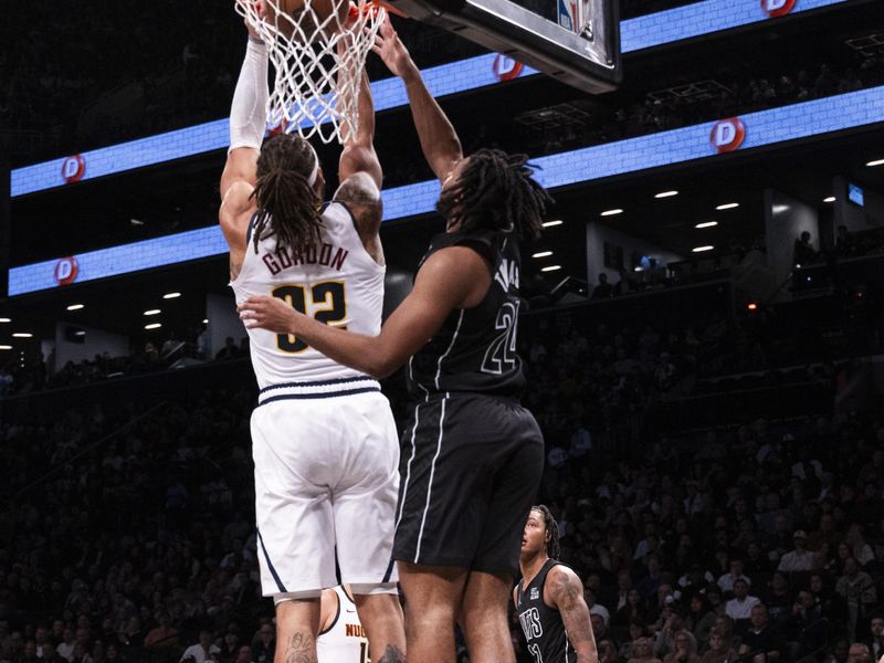 NEW YORK, NEW YORK - OCTOBER 29: Aaron Gordon #32 of the Denver Nuggets dunks over Cam Thomas #24 of the Brooklyn Nets in the third quarter of game at Barclays Center on October 29, 2024 in New York City.<p><br/></p>NOTE TO USER: User expressly acknowledges and agrees that, by downloading and or using this Photograph, user is consenting to the terms and conditions of the Getty Images License Agreement. (Photo by Michelle Farsi/Getty Images)