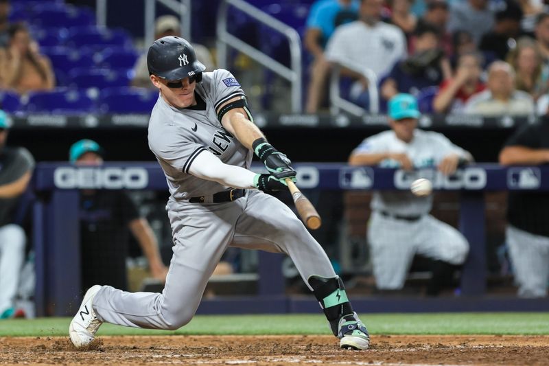 Aug 11, 2023; Miami, Florida, USA; New York Yankees center fielder Harrison Bader (22) hits a single against the Miami Marlins during the ninth inning at loanDepot Park. Mandatory Credit: Sam Navarro-USA TODAY Sports