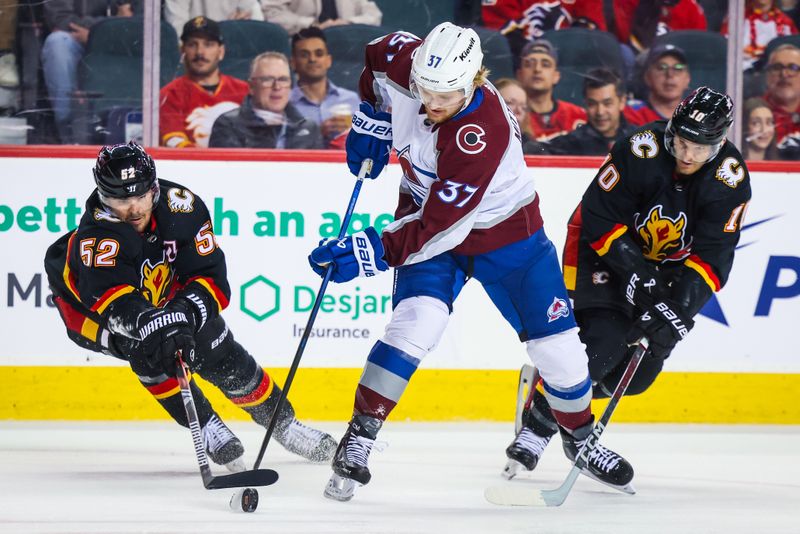 Mar 12, 2024; Calgary, Alberta, CAN; Colorado Avalanche center Casey Mittelstadt (37) and Calgary Flames defenseman MacKenzie Weegar (52) battles for the puck during the first period at Scotiabank Saddledome. Mandatory Credit: Sergei Belski-USA TODAY Sports