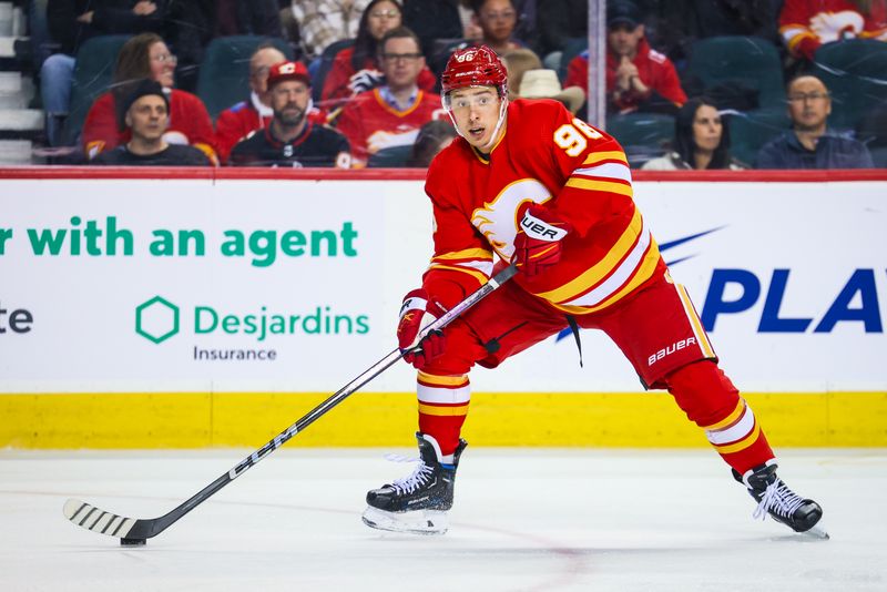 Mar 4, 2024; Calgary, Alberta, CAN; Calgary Flames left wing Andrei Kuzmenko (96) controls the puck against the Seattle Kraken during the first period at Scotiabank Saddledome. Mandatory Credit: Sergei Belski-USA TODAY Sports