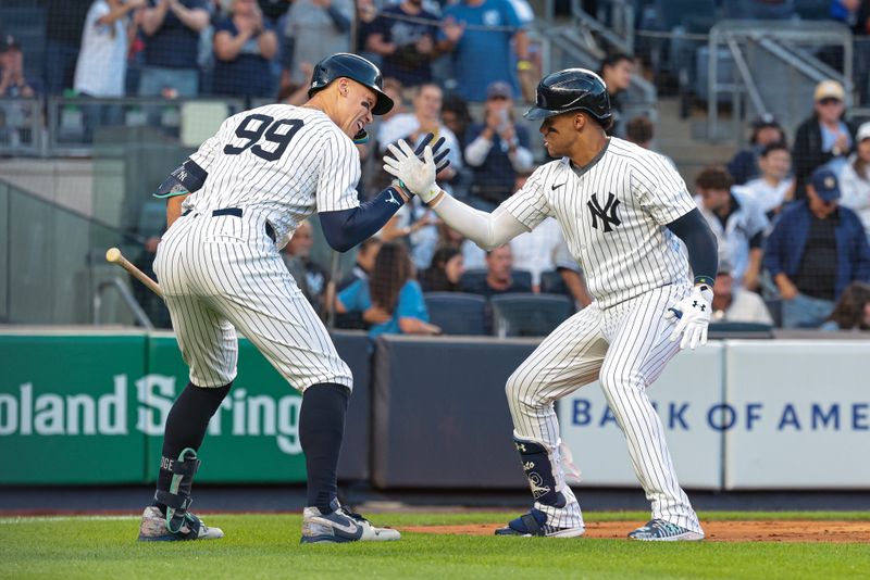 Aug 20, 2024; Bronx, New York, USA; New York Yankees right fielder Juan Soto (22) celebrates with center fielder Aaron Judge (99) after hitting a solo home run during the first inning against the Cleveland Guardians at Yankee Stadium. Mandatory Credit: Vincent Carchietta-USA TODAY Sports