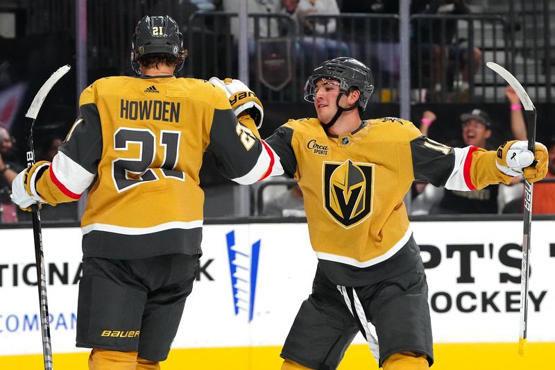 Sep 29, 2023; Las Vegas, Nevada, USA; Vegas Golden Knights center Brendan Brisson (19) celebrates with Vegas Golden Knights center Brett Howden (21) after scoring a goal against the Arizona Coyotes during the second period at T-Mobile Arena. Mandatory Credit: Stephen R. Sylvanie-USA TODAY Sports