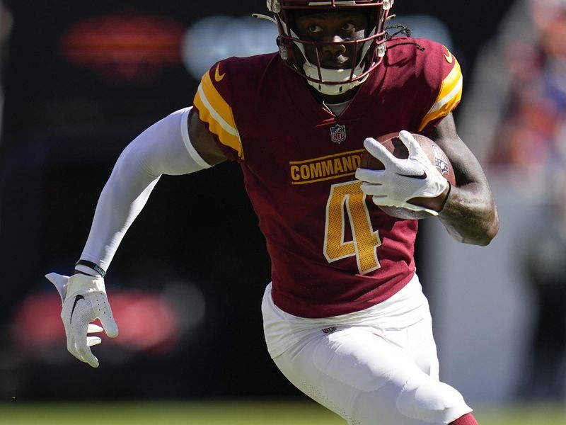 Washington Commanders wide receiver Curtis Samuel (4) runs against the Denver Broncos during an NFL football game Sunday, Sept. 10, 2023, in Denver. (AP Photo/Jack Dempsey)