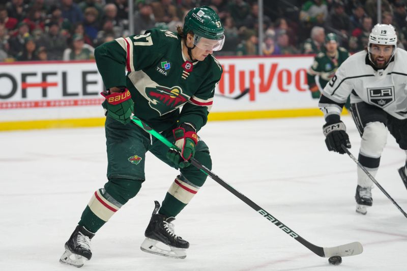 Feb 21, 2023; Saint Paul, Minnesota, USA; Minnesota Wild left wing Kirill Kaprizov (97) is pressed by Los Angeles Kings left wing Alex Iafallo (19) in the first period at Xcel Energy Center. Mandatory Credit: Matt Blewett-USA TODAY Sports