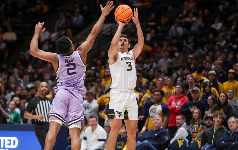 Jan 9, 2024; Morgantown, West Virginia, USA; West Virginia Mountaineers guard Kerr Kriisa (3) shoots a three pointer over Kansas State Wildcats guard Tylor Perry (2) during the second half at WVU Coliseum. Mandatory Credit: Ben Queen-USA TODAY Sports