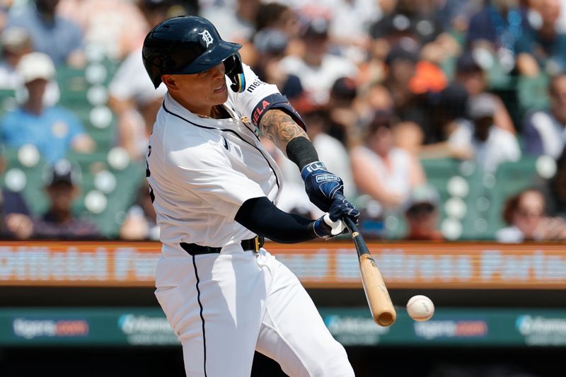 Aug 4, 2024; Detroit, Michigan, USA;  Detroit Tigers third baseman Gio Urshela (13) hits an RBI single in the second inning against the Kansas City Royals at Comerica Park. Mandatory Credit: Rick Osentoski-USA TODAY Sports