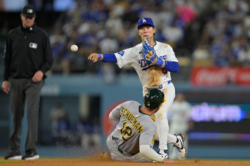 May 15, 2025; Los Angeles, California, USA; Athletics second baseman Max Schuemann (12) is out at second base as Los Angeles Dodgers second baseman Hyeseong Kim (6) turns a double play during the fifth inning of the game at Dodger Stadium. Mandatory Credit: Jayne Kamin-Oncea-Imagn Images