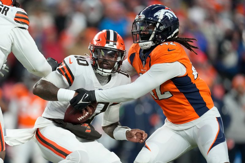 Cleveland Browns quarterback PJ Walker (10) is sacked for a 4-yard loss by Denver Broncos linebacker Nik Bonitto (42) during the second half of an NFL football game on Sunday, Nov. 26, 2023, in Denver. (AP Photo/David Zalubowski)