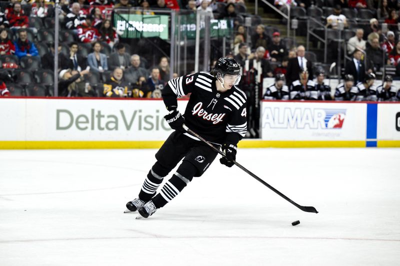 Apr 11, 2025; Newark, New Jersey, USA; New Jersey Devils defenseman Luke Hughes (43) skates with the puck during the third period against the Pittsburgh Penguins at Prudential Center. Mandatory Credit: John Jones-Imagn Images