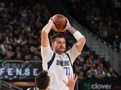 MILWAUKEE, WI - NOVEMBER 18: Luka Doncic #77 of the Dallas Mavericks looks to pass the ball during the game against the Milwaukee Bucks on November 18, 2023 at the Fiserv Forum Center in Milwaukee, Wisconsin. NOTE TO USER: User expressly acknowledges and agrees that, by downloading and or using this Photograph, user is consenting to the terms and conditions of the Getty Images License Agreement. Mandatory Copyright Notice: Copyright 2023 NBAE (Photo by Gary Dineen/NBAE via Getty Images).
