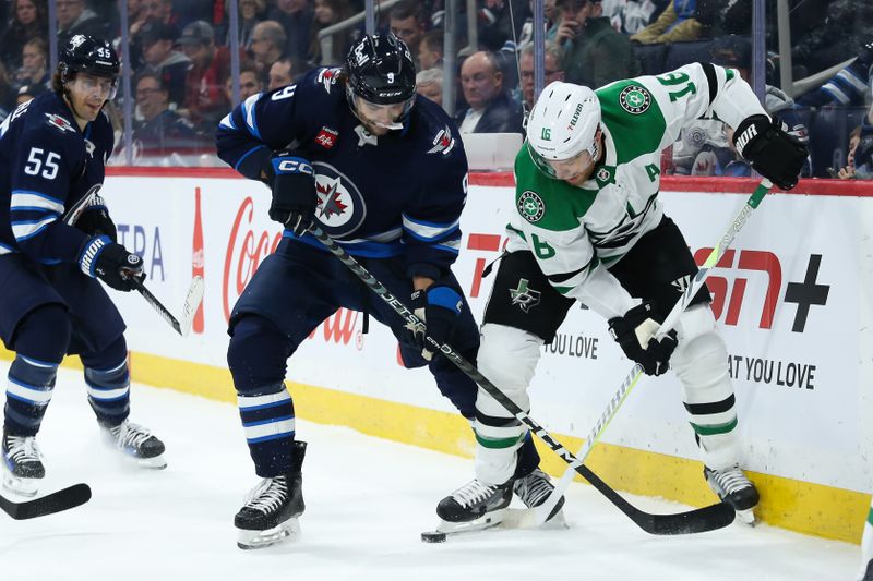 Nov 11, 2023; Winnipeg, Manitoba, CAN;  Winnipeg Jets forward Alex Iafallo (9) battles Dallas Stars forward Joe Pavelski (16) for the puck during the second period at Canada Life Centre. Mandatory Credit: Terrence Lee-USA TODAY Sports