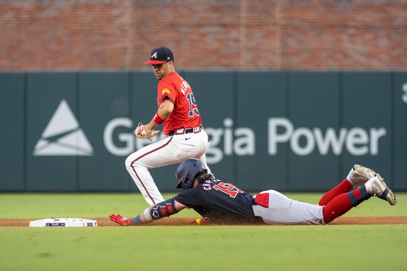 Aug 23, 2024; Cumberland, Georgia, USA; Washington Nationals third base Andres Chaparro (19) slides into second base against Atlanta Braves outfielder Whit Merrifield (15) during the fourth inning at Truist Park. Mandatory Credit: Jordan Godfree-USA TODAY Sports