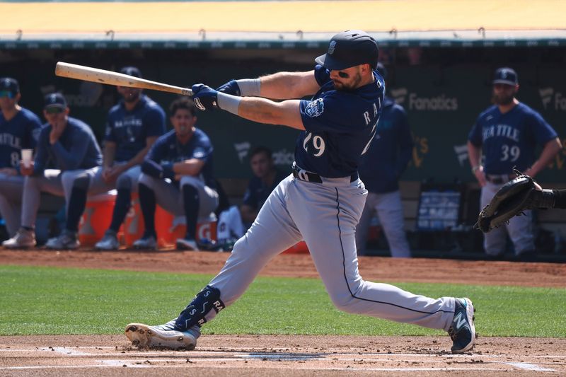 Sep 20, 2023; Oakland, California, USA; Seattle Mariners catcher Cal Raleigh (29) hits a double against the Oakland Athletics during the first inning at Oakland-Alameda County Coliseum. Mandatory Credit: Kelley L Cox-USA TODAY Sports