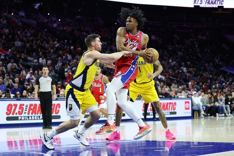 PHILADELPHIA, PENNSYLVANIA - DECEMBER 13: Ricky Council IV #14 of the Philadelphia 76ers drives to the basket against T.J. McConnell #9 of the Indiana Pacers during the second half at the Wells Fargo Center on December 13, 2024 in Philadelphia, Pennsylvania. NOTE TO USER: User expressly acknowledges and agrees that, by downloading and or using this photograph, User is consenting to the terms and conditions of the Getty Images License Agreement. (Photo by Emilee Chinn/Getty Images)