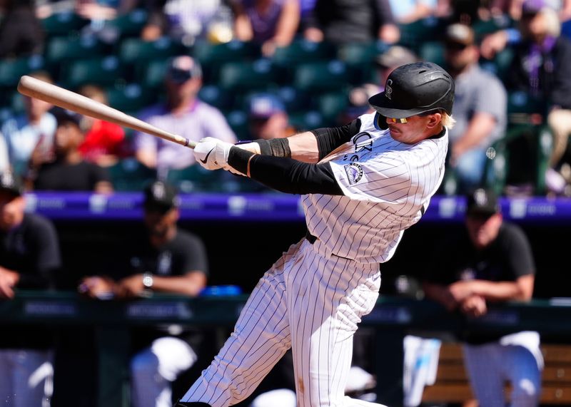 Apr 10, 2025; Denver, Colorado, USA; Colorado Rockies outfielder Zac Veen (13) doubles in the eighth inning against the Milwaukee Brewers at Coors Field. Mandatory Credit: Ron Chenoy-Imagn Images