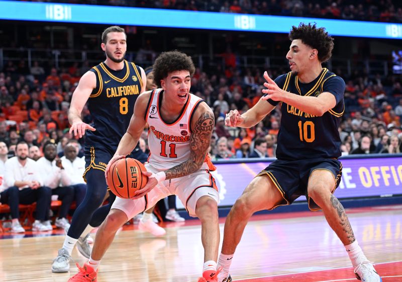 Feb 11, 2026; Syracuse, New York, USA; Syracuse Orange guard Naithan George (11) tries to move the ball past California Golden Bears guard Justin Pippen (10) and center Milos Ilic (8) in the second half at the JMA Wireless Dome. Mandatory Credit: Mark Konezny-Imagn Images
