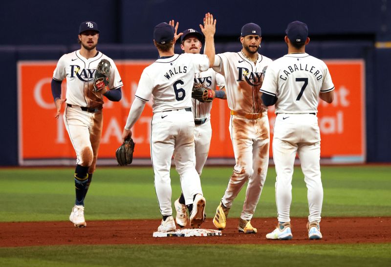 Sep 3, 2024; St. Petersburg, Florida, USA; Tampa Bay Rays outfielder Jose Siri (22), shortstop Jose Caballero (7), shortstop Taylor Walls (6), outfielder Jonny DeLuca (21) and Toutfielder Josh Lowe (15) celebrate as they beat the Minnesota Twins at Tropicana Field. Mandatory Credit: Kim Klement Neitzel-Imagn Images