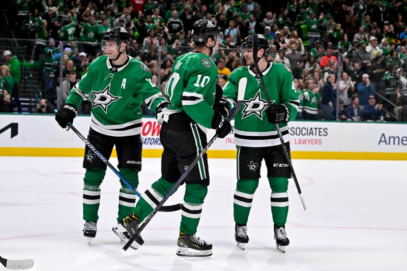 Nov 14, 2024; Dallas, Texas, USA; Dallas Stars center Oskar Back (10) and defenseman Esa Lindell (23) and defenseman Miro Heiskanen (4) celebrates after Back scores his first career NHL goal during the second period against the Boston Bruins at the American Airlines Center. Mandatory Credit: Jerome Miron-Imagn Images