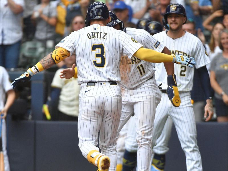 Jun 15, 2024; Milwaukee, Wisconsin, USA; Milwaukee Brewers third base Joey Ortiz (3) is congratulated by Milwaukee Brewers outfielder Jackson Chourio (11) after hitting a home run against the Cincinnati Reds in the fifth inning at American Family Field. Mandatory Credit: Michael McLoone-USA TODAY Sports