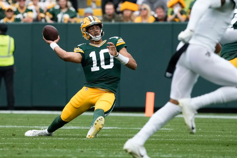 Green Bay Packers quarterback Jordan Love (10) slips as he throws on fourth down during the first half of an NFL football game against the New Orleans Saints Sunday, Sept. 24, 2023, in Green Bay, Wis. (AP Photo/Morry Gash)