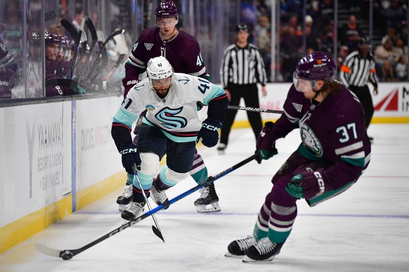 Apr 5, 2024; Anaheim, California, USA; Seattle Kraken left wing Pierre-Edouard Bellemare (41) plays for the puck against Anaheim Ducks defenseman William Lagesson (37) during the third period at Honda Center. Mandatory Credit: Gary A. Vasquez-USA TODAY Sports