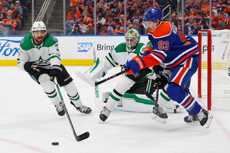 May 27, 2024; Edmonton, Alberta, CAN; Dallas Stars defensemen Chris Tanev (3) and Edmonton Oilers forward Ryan Nugent-Hopkins (93) chase a loose puck during the first period in game three of the Western Conference Final of the 2024 Stanley Cup Playoffs at Rogers Place. Mandatory Credit: Perry Nelson-USA TODAY Sports