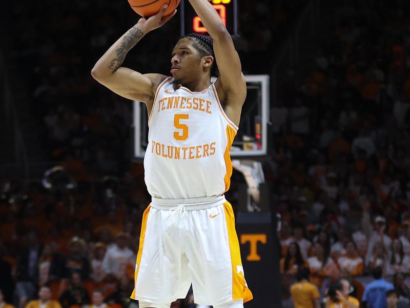 Jan 25, 2023; Knoxville, Tennessee, USA; Tennessee Volunteers guard Zakai Zeigler (5) shoots a three pointer against the Georgia Bulldogs during the first half at Thompson-Boling Arena. Mandatory Credit: Randy Sartin-USA TODAY Sports